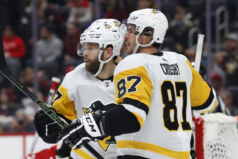 Pittsburgh Penguins right wing Bryan Rust, left, celebrates his goal with Sidney Crosby (87) in the third period of Friday's game against the Detroit Red Wings in Detroit. - Photo by Paul Sancya of The Associated Press