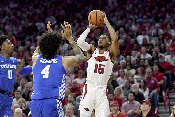 Arkansas guard Mason Jones (15) pulls up to shoot over Kentucky defenders Nick Richards (4) and Ashton Hagans (0) during the first half of an NCAA college basketball game, Saturday, Jan. 18, 2020, in Fayetteville. (AP Photo/Michael Woods)


