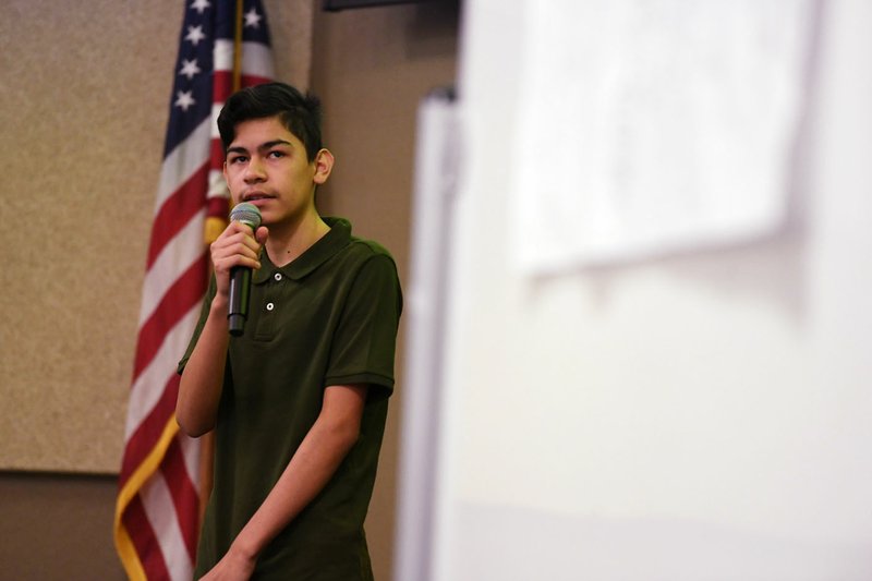 Isaias Reyes, a student at Oakdale Middle School in Rogers, presents an idea for a smartphone application for his team Thursday at the Professional Learning Center in Rogers. Thirteen teams competed to design a mobile app in the goIT event hosted by Tata Consultancy Services. Students presented their creations to a panel of judges including Mayor Greg Hines and state Rep. Jana Della Rosa. The teams were tasked with developing apps that would address issues in their communities. Visit  nwaonline.com/200117Daily/ for a daily image gallery. (NWA Democrat-Gazette/J.T. Wampler)