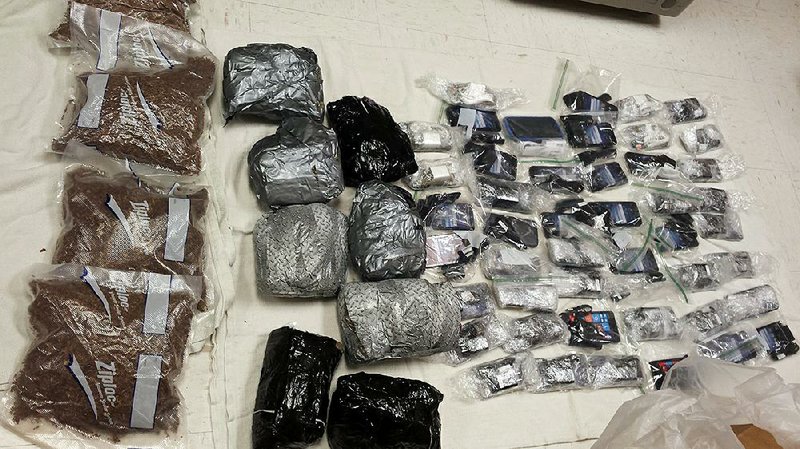 A photo provided by the Mississippi Department of Corrections shows cellphones and chargers, packets of tobacco and packets of suspected marijuana found in the bottom of a crate of meat delivered to the Parchman penitentiary in 2016.  