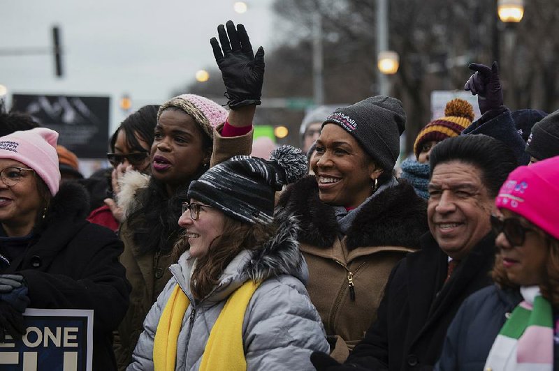 Illinois Lt. Gov. Juliana Stratton waves to the crowd Saturday as her name is called during the Women’s March in downtown Chicago. More photos at arkansasonline.com/119women/. 