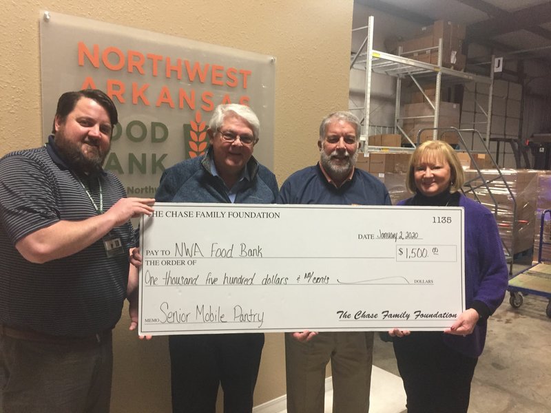 The Chase Family Foundation recently donated $1,500 to the Northwest Arkansas Food Bank. Pictured are Mike Williams of the Food Bank, Kent Eikenberry, president/CEO of the Food Bank, Dr. John Bakker and Susan Chase of the Chase Family Foundation. (Courtesy Photo)