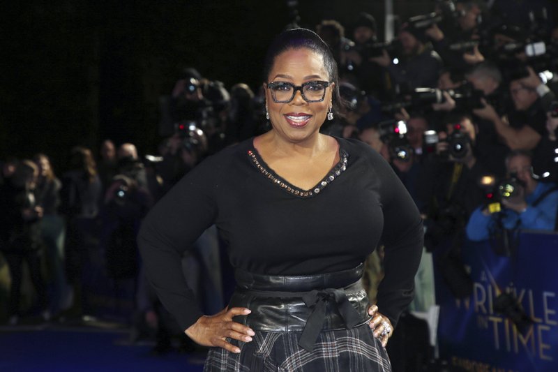 FILE - In this March 13, 2018, file photo, actress Oprah Winfrey poses for photographers upon arrival at the premiere of the film &quot;A Wrinkle In Time&quot; in London. Winfrey said Friday, Jan. 17, 2020, that Russell Simmons attempted to pressure her about her involvement with the documentary, &#x201c;On the Record,&quot; in which several women detail sexual abuse allegations against the rap mogul, but his efforts were not what prompted her to leave the project. (Photo by Joel C Ryan/Invision/AP, File)