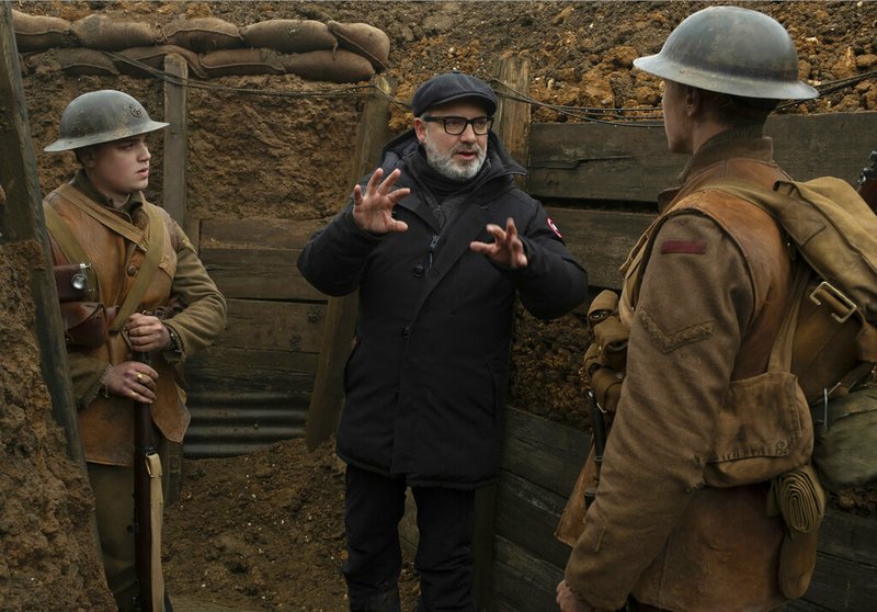 This image released by Universal Pictures shows Dean-Charles Chapman, left, director Sam Mendes, center, and George MacKay on the set of "1917." On Monday, Jan. 13, Mendes was nominated for an Oscar for best director for his work on the film. (Fran&#231;ois Duhamel/Universal Pictures via AP)