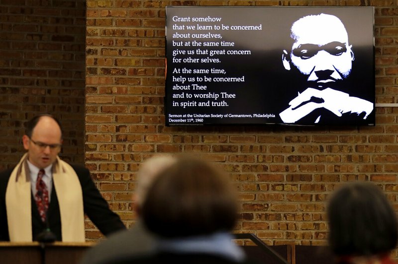 In this Jan. 17, 2020, photo Rabbi Fred Reeves, left, speaks during the Friday Shabbat Service at KAM Isaiah Israel in Chicago. On the eve of the day set aside to honor an African American who strove against hate and preached racial and social justice, some worry the nation is becoming more divided. (AP Photo/Nam Y. Huh)