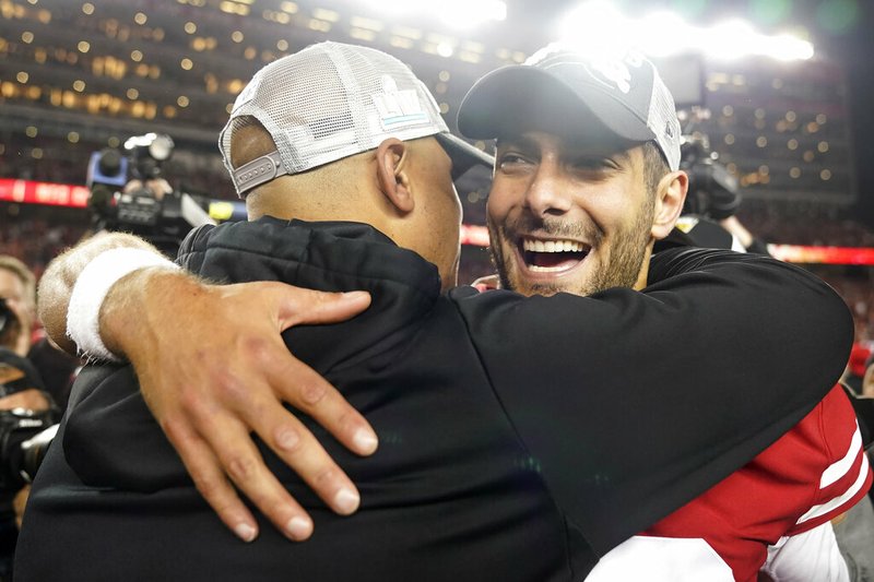 San Francisco 49ers quarterback Jimmy Garoppolo celebrates with assistant coach Miles Austin after Sunday's NFC Championship football game against the Green Bay Packers in Santa Clara, Calif. The 49ers won 37-20 to advance to Super Bowl LIV against the Kansas City Chiefs.