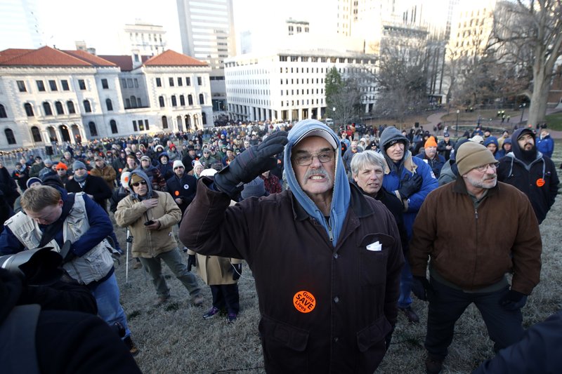 Demonstrators stand on the capitol grounds ahead of a pro gun rally, Monday, Jan. 20, 2020, in Richmond, Va. (AP Photo/Steve Helber)

