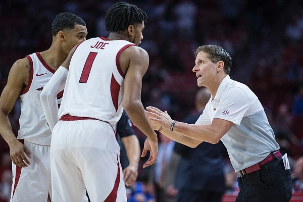 Eric Musselman, Arkansas head coach, confers with Isaiah Joe (1) and Jalen Harris in the second half vs Kentucky Saturday, Jan. 18, 2020, at Bud Walton Arena in Fayetteville. Go to nwaonline.com/photos to see more photos.