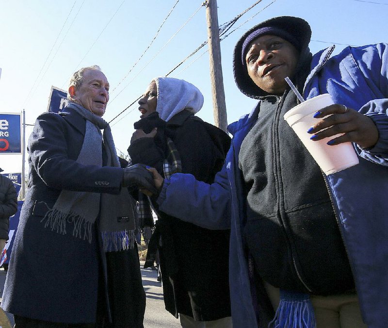 Democratic presidential candidate and former New York City Mayor Michael Bloomberg visits with Janelle Toombs (middle) and Yolanda Radcliff at Monday’s Martin Luther King Jr. Day parade in Little Rock.