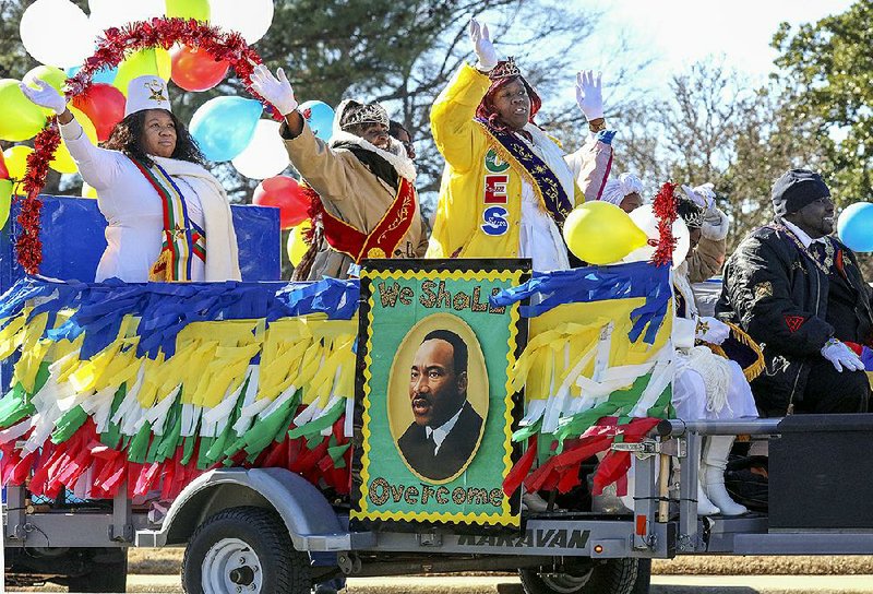 Members of the Daughters of Ruth Order of the Eastern Star wave as they travel toward the state Capitol Monday morning. Martin Luther King Jr.’s Birthday was celebrated in Little Rock by several events, including a parade Monday morning. More photos at arkansasonline.com/121mlk/  