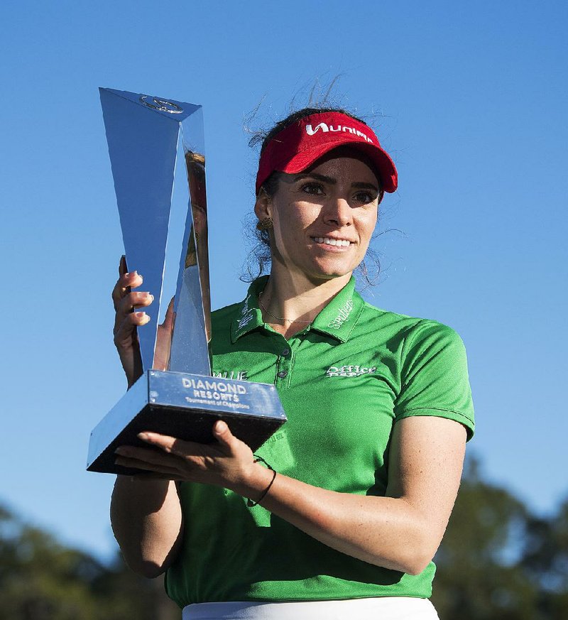Former University of Arkansas star Gaby Lopez holds the trophy after winning the Tournament of Champions on Monday in Lake Buena Vista, Fla. Lopez defeated Nasa Hataoka in a seven-hole playoff that took an extra day to finish after play was halted Sunday because of darkness.