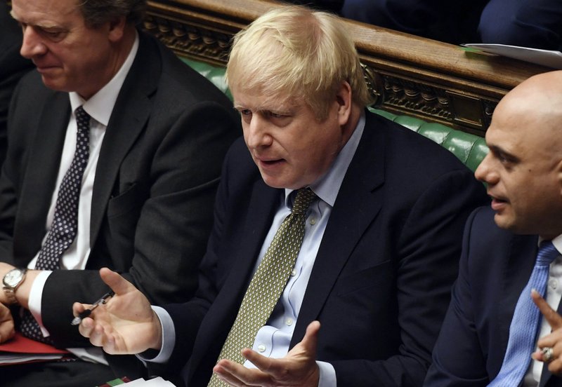 In this handout photo provided by the House of Commons, Britain's Prime Minister Boris Johnson gestures during the first Prime Minister's Questions of the year, in the House of Commons in London, Wednesday, Jan. 8, 2020. The president of the European Commission warned Britain on Wednesday that it won&#x2019;t get the &#x201c;highest quality access&#x201d; to the European Union's market after Brexit unless it makes major concessions. (Jessica Taylor/House of Commons via AP)