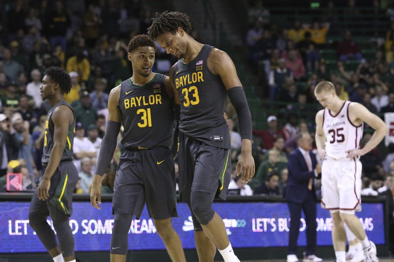 Baylor forward Freddie Gillespie (33) and Baylor guard MaCio Teague (31) smile in the second half of Monday's game against Oklahoma in Waco, Texas. - Photo by Jerry Larson of The Associated Press