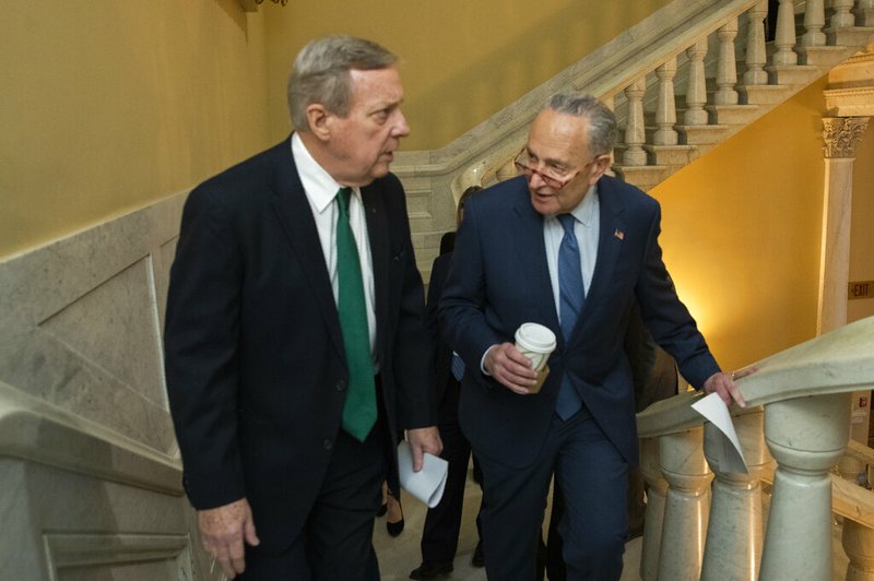 Democratic leader Sen. Chuck Schumer, D-N.Y., right, and Sen. Dick Durbin, D-Ill., walk on the steps in the U.S. Capitol on the first full day of the impeachment trial of President Donald Trump on charges of abuse of power and obstruction of Congress in Washington, Tuesday, Jan. 21, 2020. (AP Photo/Manuel Balce Ceneta)