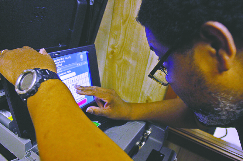 installation: Election Systems Software Senior Field Service Technician Julian Hendrickson completes the installation of a new DS2000 tabulator last year for Union County.