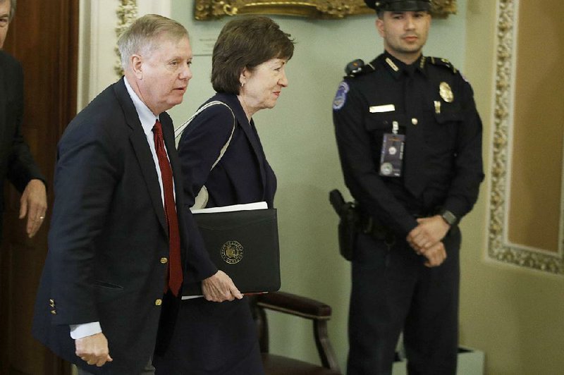 U.S. Sen. Susan Collins walks through the Capitol on Tuesday with Sen. Lindsey Graham as they arrive for the impeachment trial.
(AP/Steve Helber)