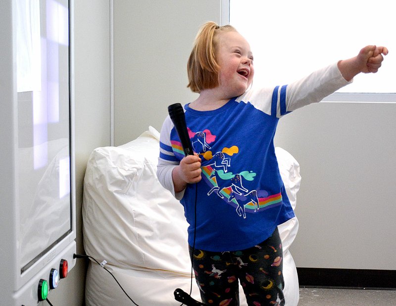 Janelle Jessen/Herald-Leader Carrie Grunig, 8, plays with a sight and sound panel in the multi-sensory room during the grand opening of the new Ability Tree facility on Saturday. The event included special speakers, a ribbon cutting ceremony and an open house. Operations at the new facility began on Tuesday. For more photos of the event see page 6A.