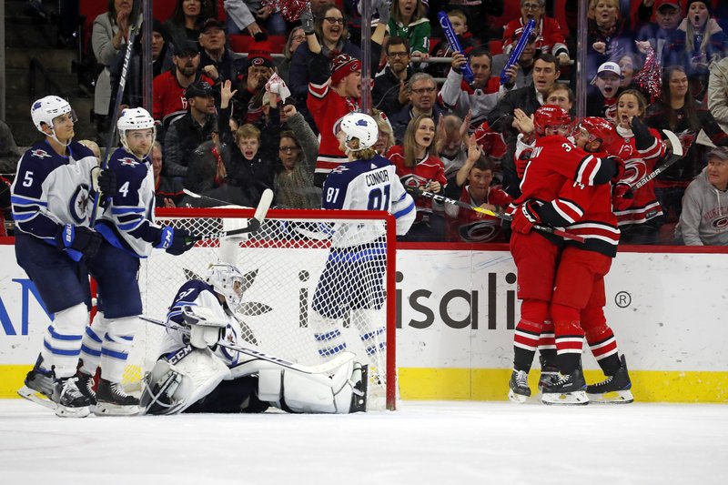 Carolina Hurricanes' Justin Williams (14), right, is congratulated on his goal by teammate Andrei Svechnikov (37), of Russia, during the third period of Tuesday's game against the Winnipeg Jets in Raleigh, N.C. - Photo by Karl B DeBlaker of The Associated Press