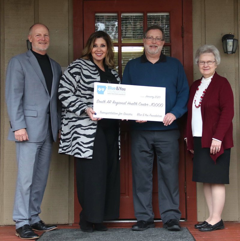 Bart Vane and Renay Turner of Arkansas Blue Cross, El Dorado Connections advisory council chair Bill Odom and executive director Julia Amis pose for a photo during a check presentation from the Blue & You Foundation Jan. 22 outside of El Dorado Connections. The $10,000 check is grant from the foundation to benefit the El Dorado Express Program.