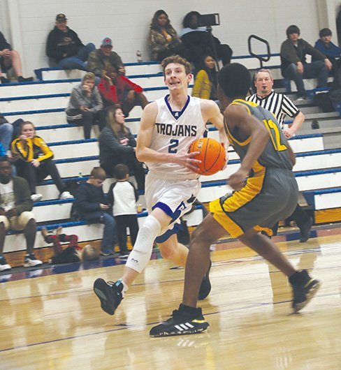 Siandhara Bonnet/News-Times Parkers Chapel's Preston Stivender drives to the basket during the Trojans' 8-2A contest against Hampton earlier this season at Parkers Chapel. The Trojans picked up a season sweep of the Bulldogs with a 69-55 win Tuesday at Hampton. Strong also posted a win in 8-1A play Tuesday, rolling to a 82-59 win over Hermitage.