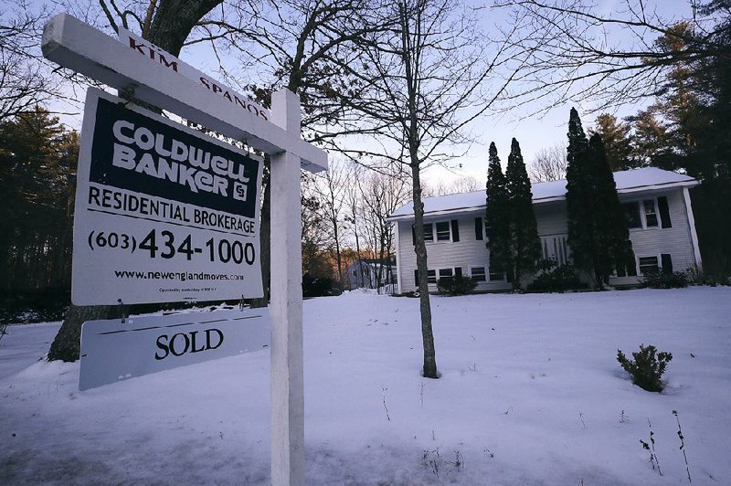 Sales of previously owned U.S. homes jumped in December as lower interest rates lured buyers.
(AP/Charles Krupa)