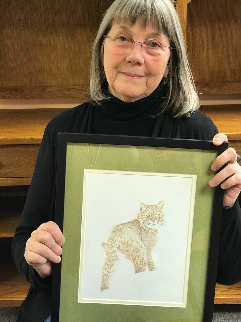 Kathy McGregor, founder of the Prison Story Project, holds a piece of art created by an inmate on Death Row in the Arkansas super-max prison called the Varner Unit. What began as a storytelling project has become a prison ministry for McGregor. (NWA Democrat-Gazette/ Becca Martin-Brown)