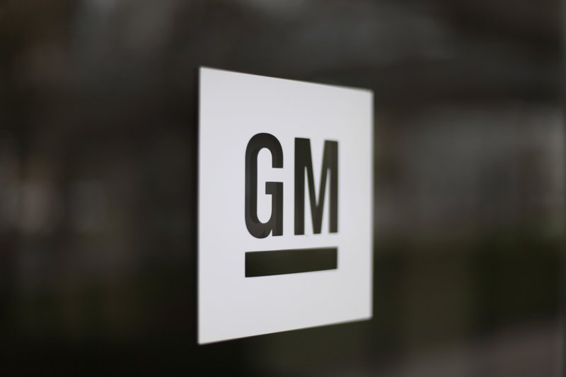 FILE - This Friday, May 16, 2014, file photo, shows the General Motors logo at the company's world headquarters in Detroit. Michigan on Wednesday, Jan. 22, 2020, agreed to revise decade-long tax breaks for General Motors in exchange for the company's commitment to spend at least $3.5 billion more over 10 years, including to build electric pickup trucks in Detroit. (AP Photo/Paul Sancya, File)