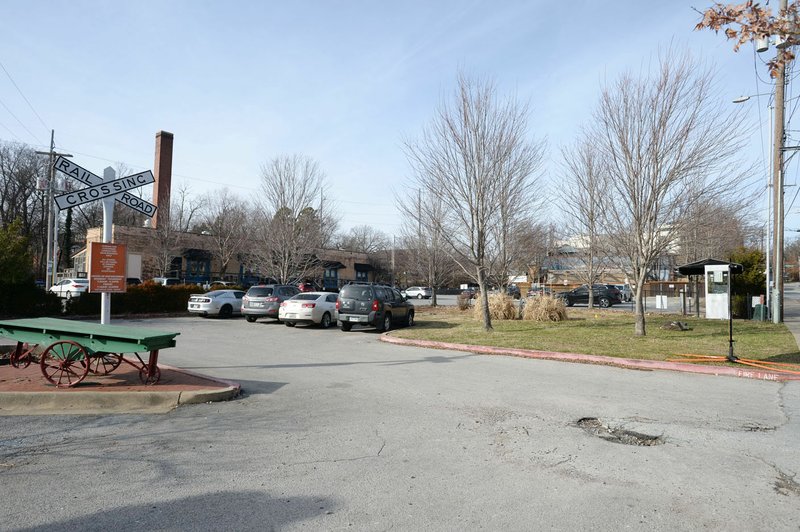 Cars are parked Tuesday at the depot parking lot on West Avenue in Fayetteville. The City Council selected the site as the potential location for a new parking deck downtown. (NWA Democrat-Gazette/Andy Shupe)