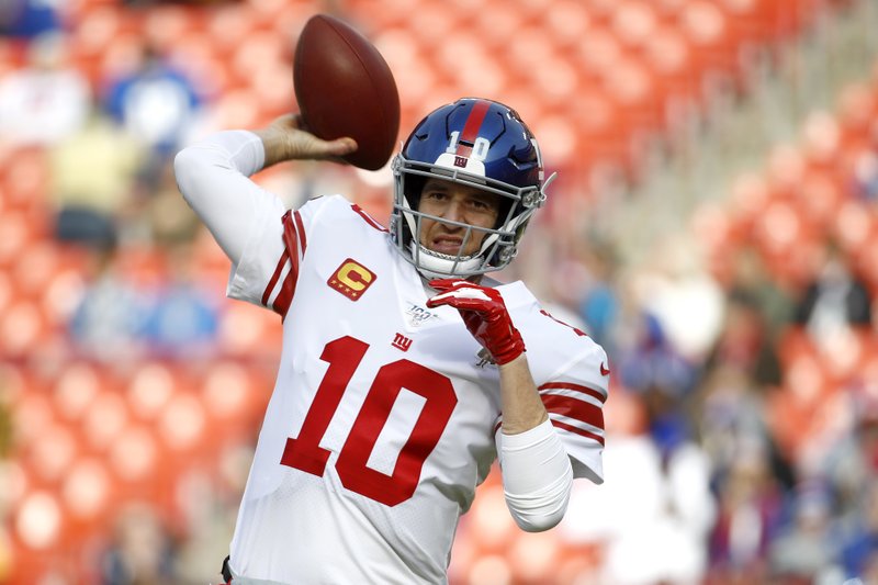 New York Giants quarterback Eli Manning works out prior to a Dec. 22, 2019, NFL game against the Washington Redskins in Landover, Md. Manning, who led the Giants to two Super Bowls in a 16-year career that saw him set almost every team passing record, has retired. The Giants said Wednesday that Manning would formally announce his retirement on Friday. - Photo by Patrick Semansky of The Associated Press