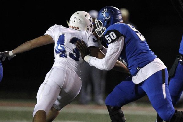 Conway offensive lineman Robert Scott (50) blocks a Rogers pass rusher during a game Friday, Nov. 9, 2018, at John McConnell Stadium in Conway. 