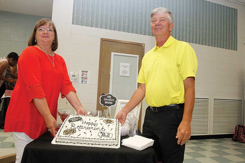 Terrance Armstard/News-Times In this file photo, Pat and Gary Don Smith show the cake at their retirement celebration held in the cafeteria at the former Union High School in Old Union. Smith was elected to the AHSCA Hall of Fame Thursday.