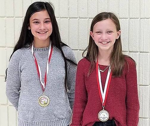 Ansley Stultz (right) won the Columbia County Spelling Bee earlier this month. The win marks the second time in as many years that the Magnolia fifth-grader took home the honors. Also pictured is runner-up, Anistyn Nolte of Taylor.