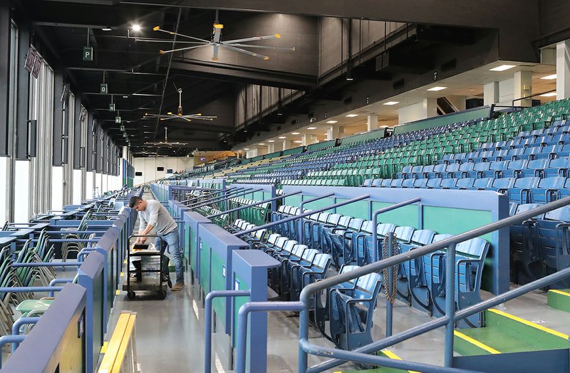 A worker at Oaklawn Racing Casino Resort prepares the grandstand for the beginning of the 2020 live race meet in January. - Photo by Richard Rasmussen of The Sentinel-Record