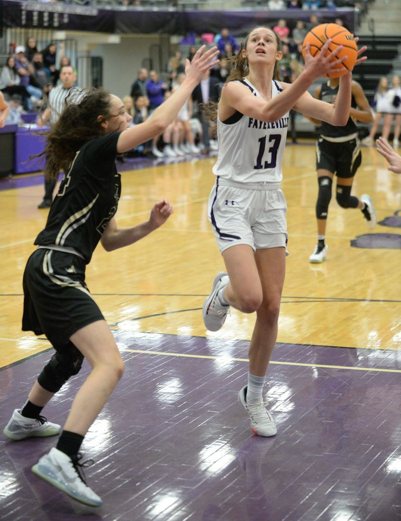 Fayetteville's Sasha Goforth (13) drives into the lane Friday, Jan. 17, 2020, as she is pressured by Emily Sanders Bentonville's Riley Hayes during the first half of play in Bulldog Arena in Fayetteville. Visit nwaonline.com/prepbball/ for a gallery from the games. (NWA Democrat-Gazette/Andy Shupe)