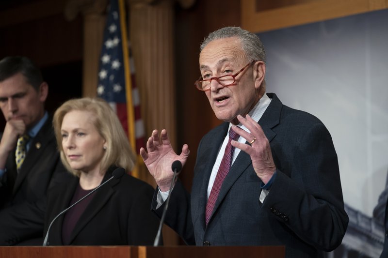 Senate Minority Leader Chuck Schumer, D-N.Y., joined from left by Sen. Martin Heinrich, D-N.M., and Sen. Kirsten Gillibrand, D-N.Y., talks to reporters about the impeachment trial of President Donald Trump on charges of abuse of power and obstruction of Congress, in Washington, Friday, Jan. 24, 2020. (AP Photo/J. Scott Applewhite)

