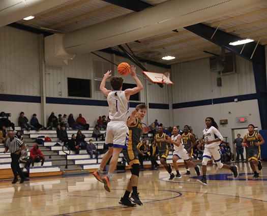 Siandhara Bonnet/News-Times Parkers Chapel's Caleb Jacobs leaps for the ball during the Trojans' 8-2A game against Hampton earlier this season. Parkers Chapel's basketball teams swept Lafayette County Thursday.