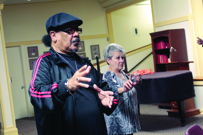 Drawing the Bow: Attendees of Dr. Laurence Hamburg’s weekly Tai Chi class practice drawing the bow to shoot the hawk, the third motion in the Tai Chi routine Eight Pieces of Brocade.