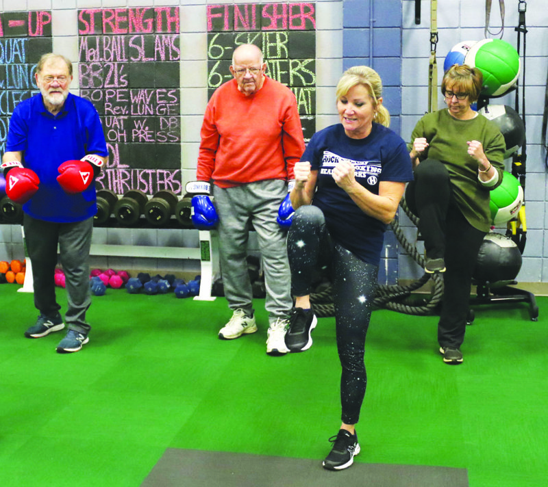 Rock Steady: Coach Rhonda Sayers leads volunteers, boxers and cornermen in the finisher workout Nov. 13 on the second floor of HealthWorks Fitness Center. The program is designed specifically for those with Parkinson's Disease.