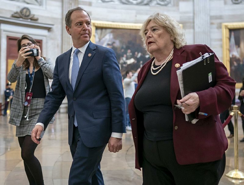 House impeachment managers Adam Schiff and Zoe Lofgren walk through the Capitol rotunda on Friday. Schiff, closing out the House case against President Donald Trump, warned that left unchecked, Trump would seek foreign election interference again. More photos at arkansasonline.com/125trial/.