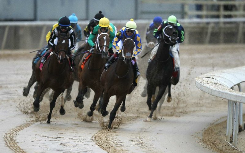 FILE — Gold Street and jockey Martin Garcia (second from right) lead the pack into the first turn in the Smarty Jones Stakes during the opening day of the live racing season at Oaklawn in Hot Springs in this 2020 file photo.