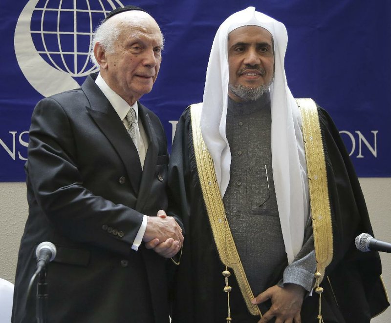 Mohammad Abdulkarim Al-Issa, Secretary-General of the Muslim World League, right, and Rabbi Arthur Schneier, President of the Appeal of Conscience Foundation, pose for a picture after signing an agreement at Park East Synagogue in New York, Monday, April 29, 2019. Al-Issa and Schneier signed the agreement to coordinate their efforts to protect religious sites and worshippers, of any religion, from violent attacks.