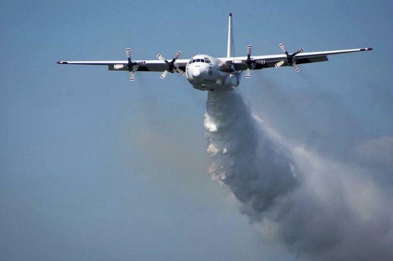 A C-130 Hercules water-tanker plane like this one, shown in a Rural Farm Service photo dropping water on Australian wildfires, crashed Thursday, killing three American firefighters.
(AP)