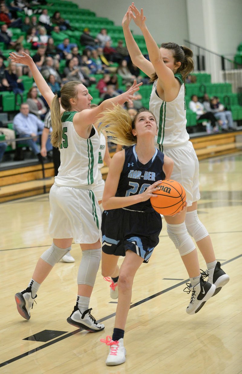 Har-Ber's Mary Blake Martfeld (center) drives to the lane Friday, Jan. 24, 2020, past Van Buren's Elizabeth Rainwater (left) and Carter Schmidt (right) during the first half of play in Clair Bates Athletic Arena at Van Buren High School. Visit nwaonline.com/prepbball/ for today's photo gallery. (NWA Democrat-Gazette/Andy Shupe)