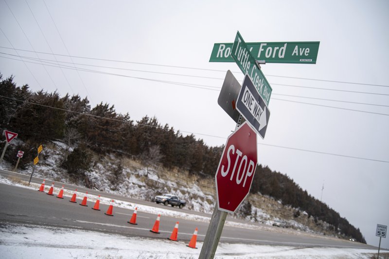 Tuttle Creek Boulevard is closed off with cones at the Rocky Ford Avenue intersection in Manhattan, Kan., Friday, Jan. 24, 2020. A snowplow struck and killed two pedestrians in Kansas before sunrise Friday after a winter storm coated parts of the Midwest with snow. (Nickolas Oatley/The Manhattan Mercury via AP)