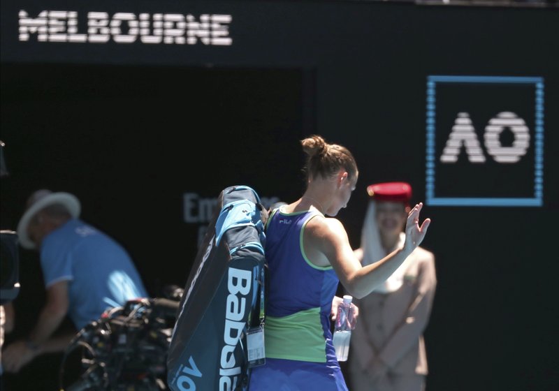 Karolina Pliskova of the Czech Republic waves as she leaves Rod Laver Arena after her third round loss to to Russia's Anastasia Pavlyuchenkova at the Australian Open tennis championship in Melbourne, Australia, Saturday, Jan. 25, 2020. (AP Photo/Dita Alangkara)