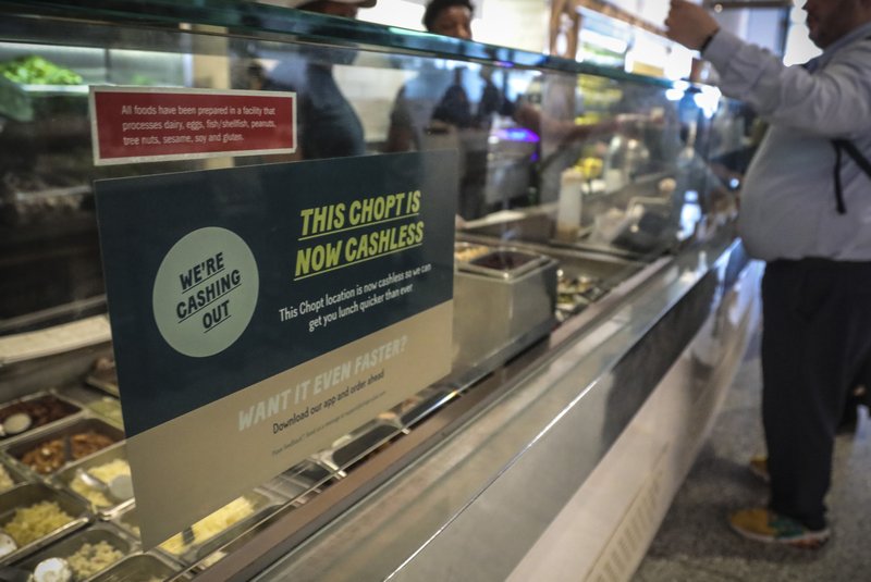 A Chopt restaurant in New York displays a sign  this week alerting customers  that  it does not  take cash, which would be prohibited under a new city measure.
(AP/Bebeto Matthews)