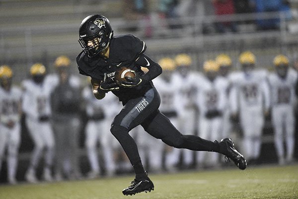 Bentonville receiver Chas Nimrod scores a touchdown during a game against Little Rock Catholic on Friday, Nov. 22, 2019, at Tiger Stadium in Bentonville. 