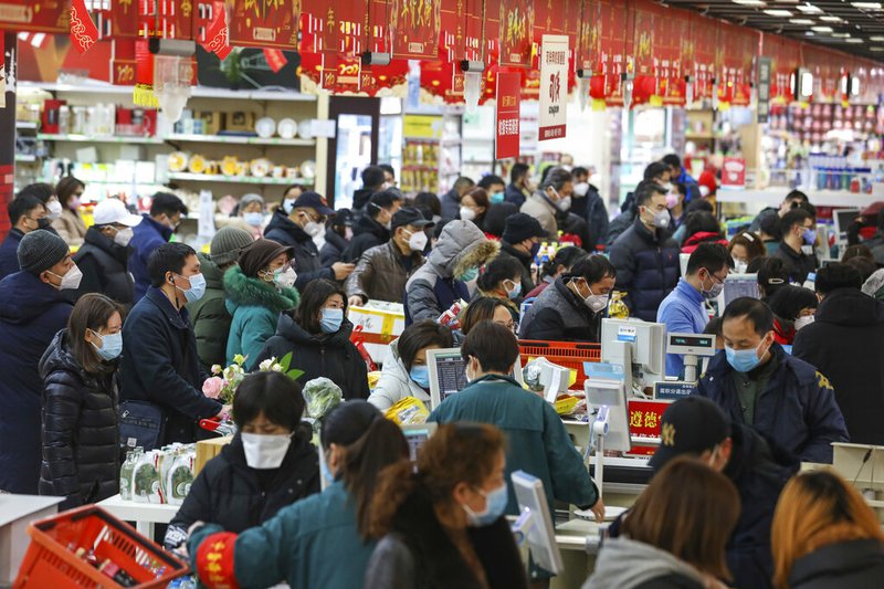 Shoppers wearing face masks pay for their groceries at a supermarket in Wuhan in central China's Hubei province, Saturday, Jan. 25, 2020. The virus-hit Chinese city of Wuhan, already on lockdown, banned most vehicle use downtown and Hong Kong said it would close schools for two weeks as authorities scrambled Saturday to stop the spread of an illness that is known to have infected more than 1,200 people and killed 41, according to officials. 

