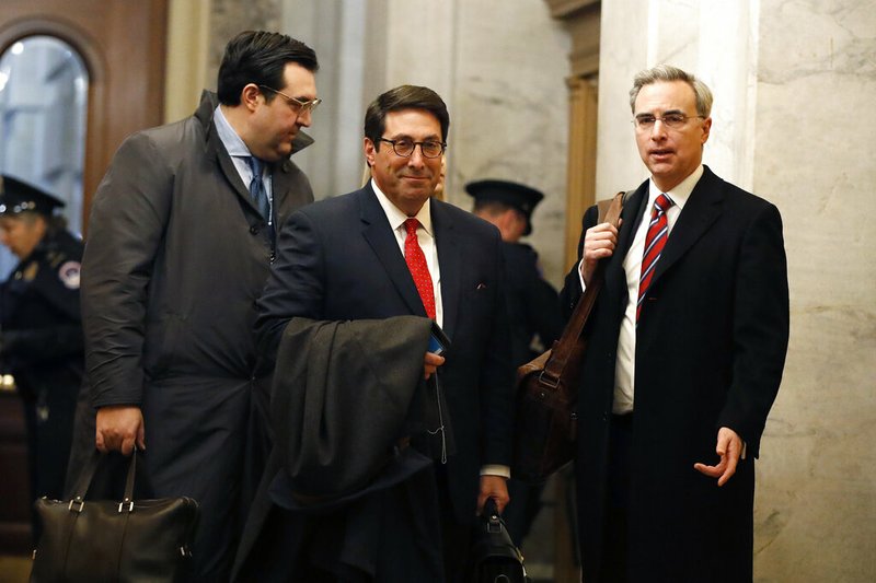 President Donald Trump's personal attorney Jay Sekulow, center, stands with his son, Jordan Sekulow, left, and White House Counsel Pat Cipollone, while arriving at the Capitol in Washington during the impeachment trial of President Donald Trump on charges of abuse of power and obstruction of Congress, Saturday, Jan. 25, 2020. (AP Photo/Julio Cortez)