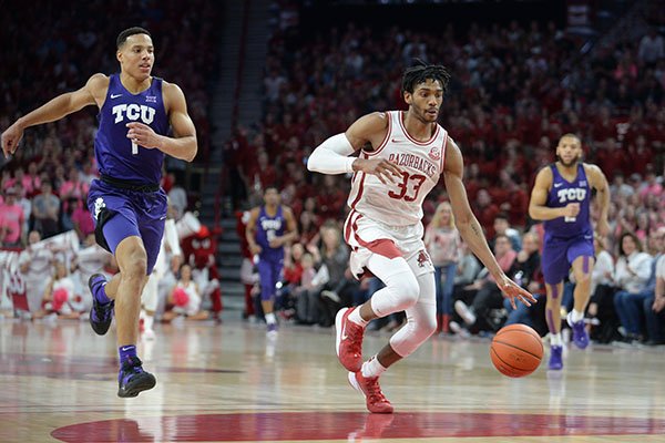 Arkansas guard Jimmy Whitt Jr. (33) drives to the basket in transition Saturday, Jan. 25, 2020, ahead of TCU guard Desmond Bane during the first half of play in Bud Walton Arena. 